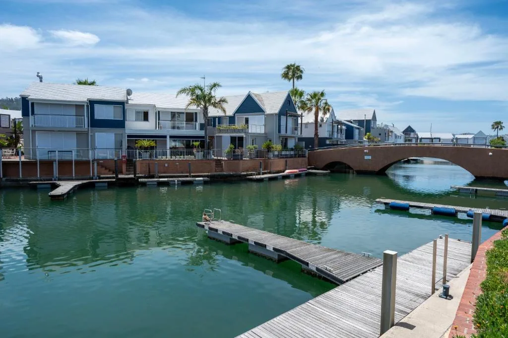 Waterfront properties with wooden dock and lagoon canal view