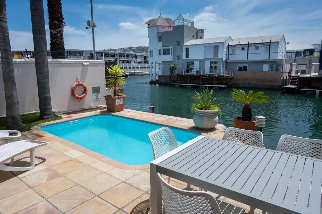 Waterfront swimming pool with deck seating and lagoon views in Knysna