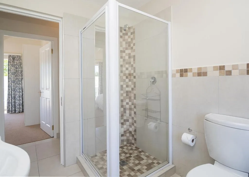 Modern bathroom with glass-enclosed shower and ceramic tile details