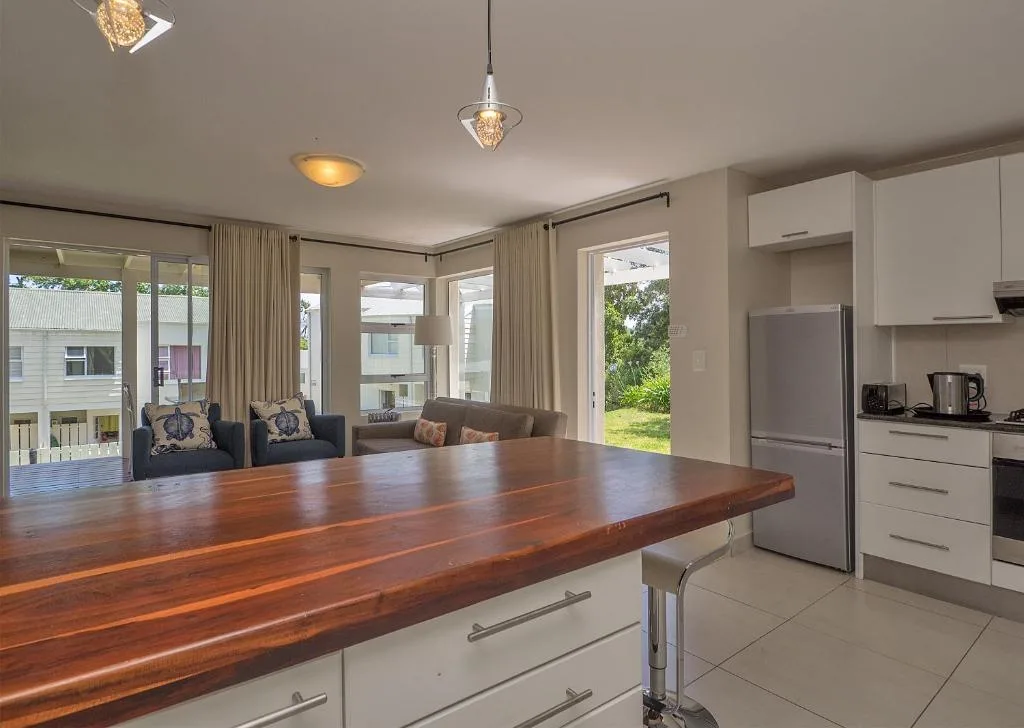 Modern kitchen with wooden island counter and stainless steel appliances