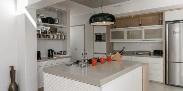 Modern kitchen with island counter, pendant lighting, and stainless steel appliances