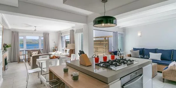 Modern kitchen with gas stove, island counter, and ocean view windows
