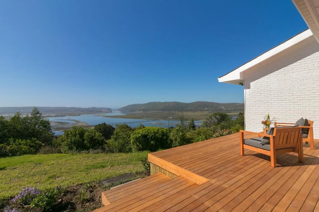 Wooden deck with seating overlooking lagoon and mountains