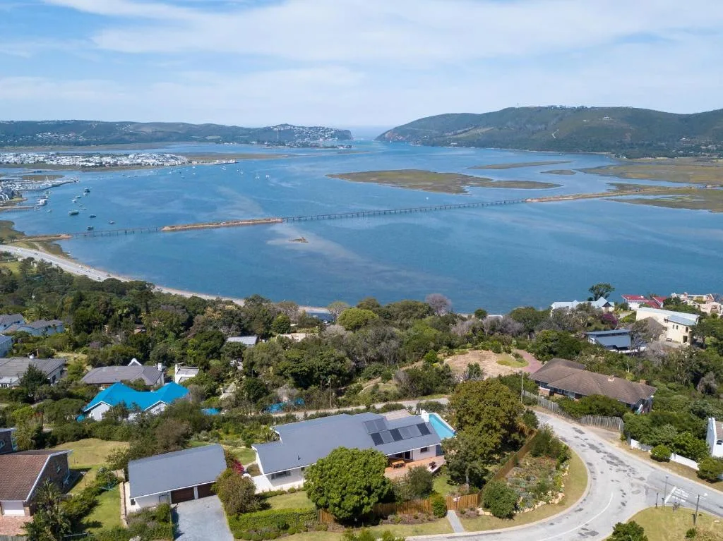 Aerial view of Knysna Lagoon with bridge, boats, and surrounding hills