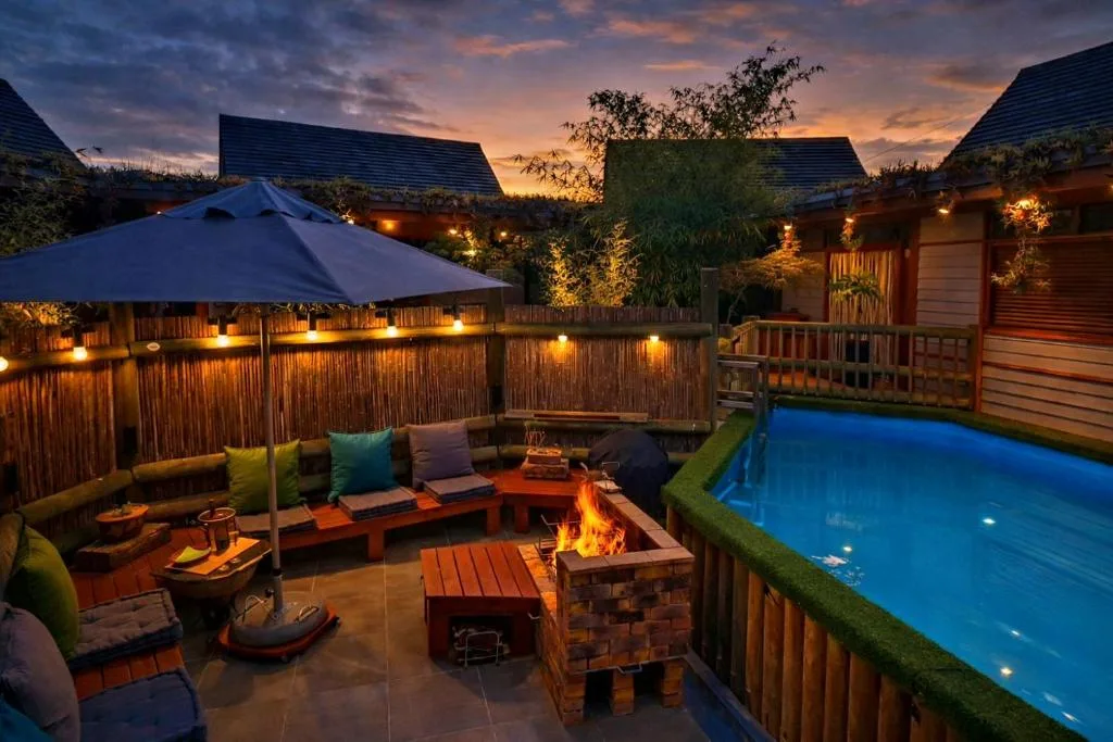 Twilight view of illuminated outdoor entertaining area with firepit and pool