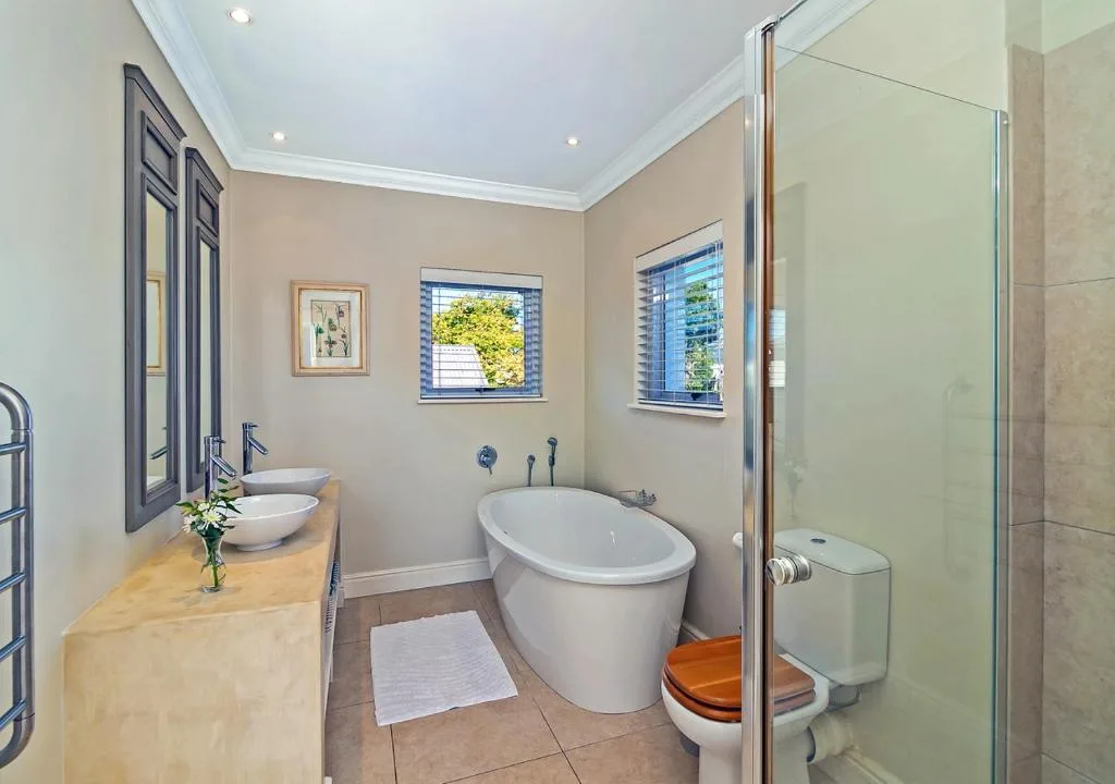 Luxurious bathroom with freestanding tub, dual vanity, and walk-in shower