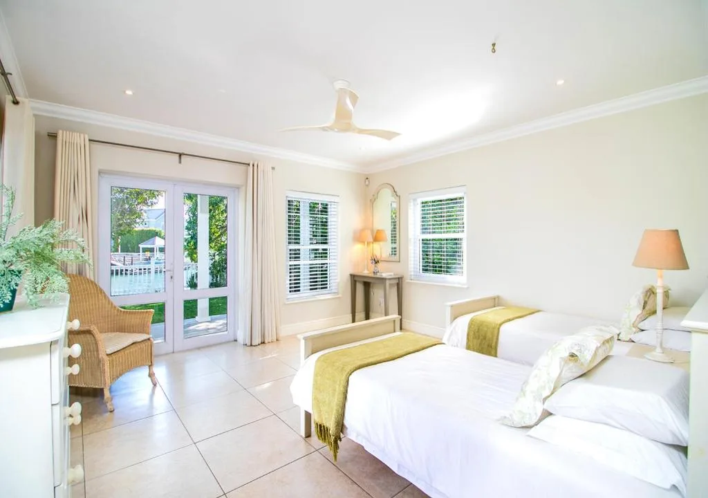 Spacious bedroom with two beds, deck access, and natural light