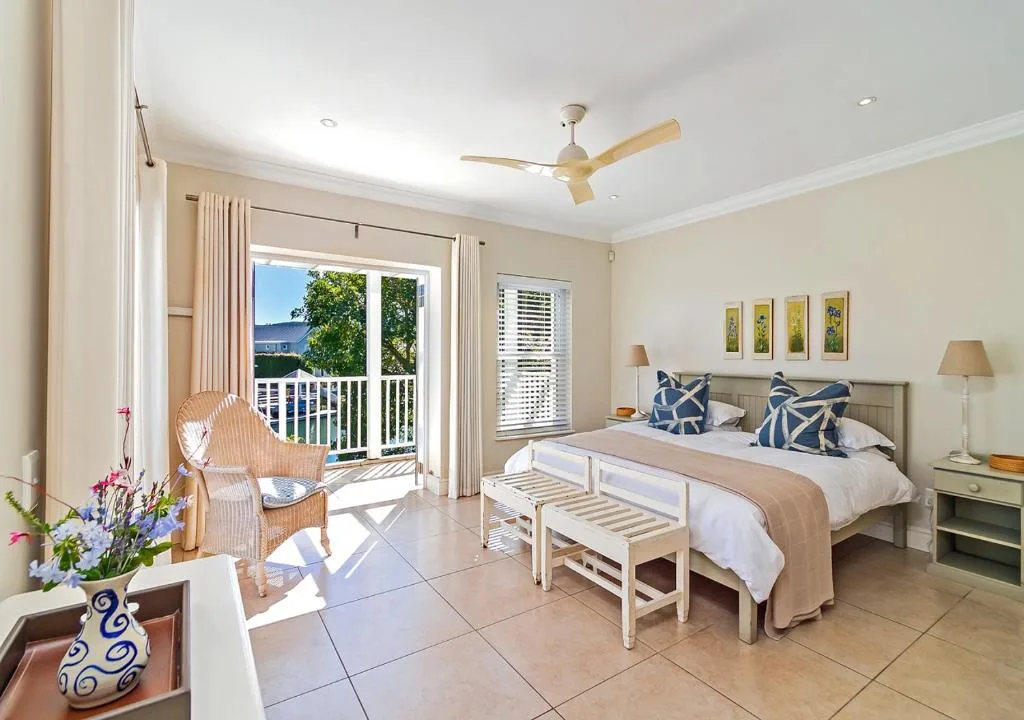 Spacious bedroom with queen bed, deck access, and mountain views