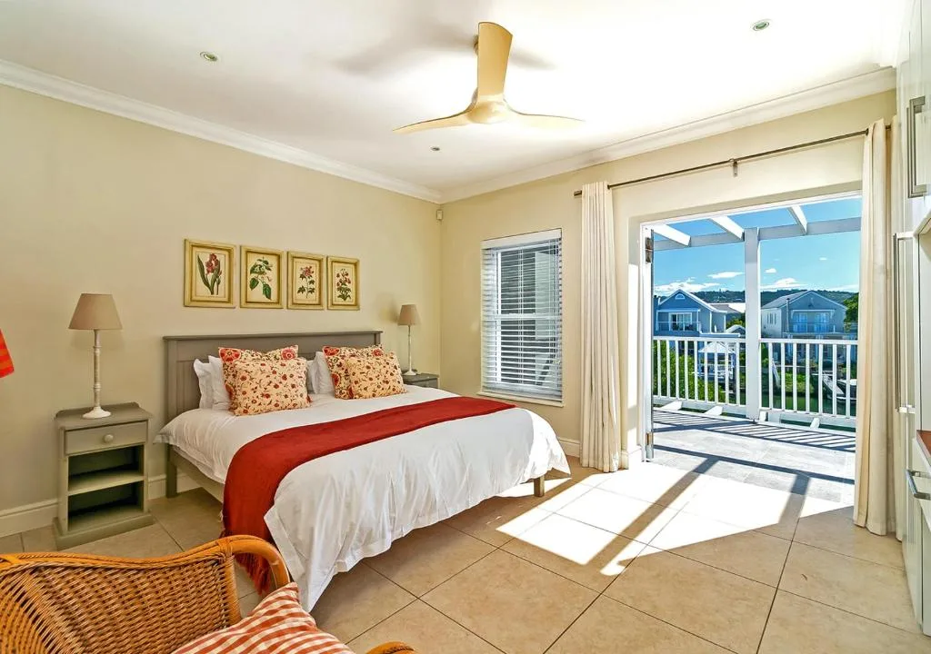 Bright bedroom with bed, mountain views through balcony doors