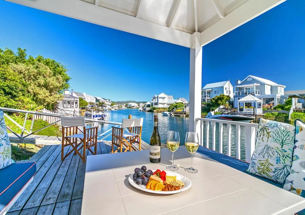Waterfront deck with wine, fruit platter, and canal views
