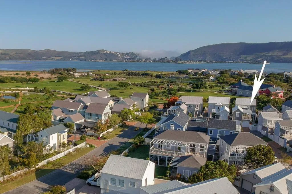 Aerial view of coastal property with mountains and blue lagoon beyond