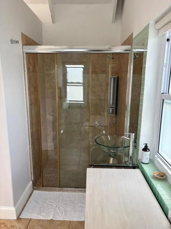 Modern bathroom with glass shower enclosure and vessel sink vanity