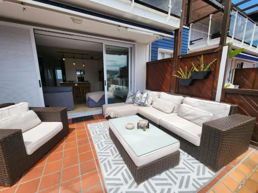 Outdoor patio with wicker furniture and mountain views overlooking Knysna