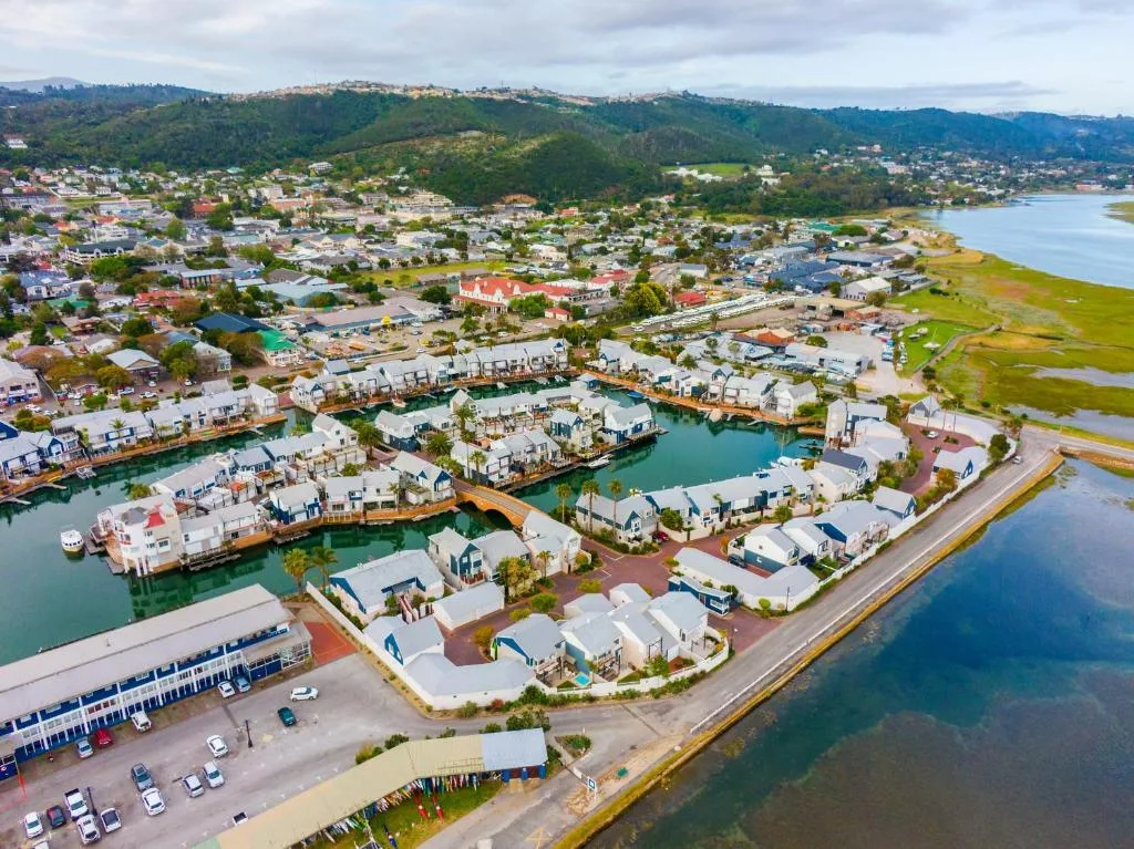 Aerial view of Knysna waterfront development with lagoon and mountains