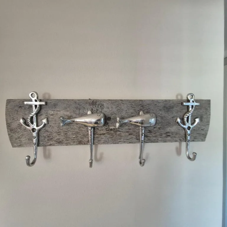 Nautical wall-mounted coat rack with anchors and fish hooks