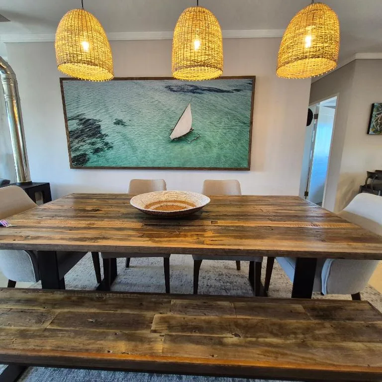 Modern dining room with wooden table and woven pendant lights