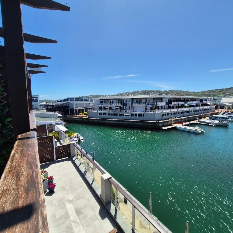 Stunning waterfront view of Knysna lagoon with boats and hillside beyond