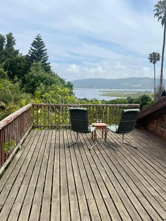 Wooden deck with chairs overlooking Knysna lagoon and mountains