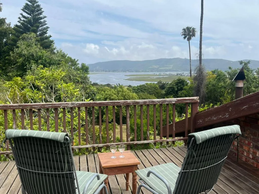 Scenic lagoon and mountain vista from elevated deck with comfortable seating