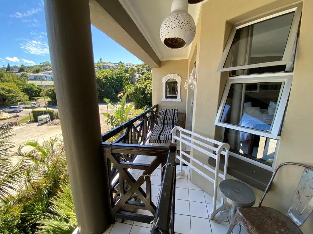 Covered balcony with seating overlooking Knysna gardens and suburbs