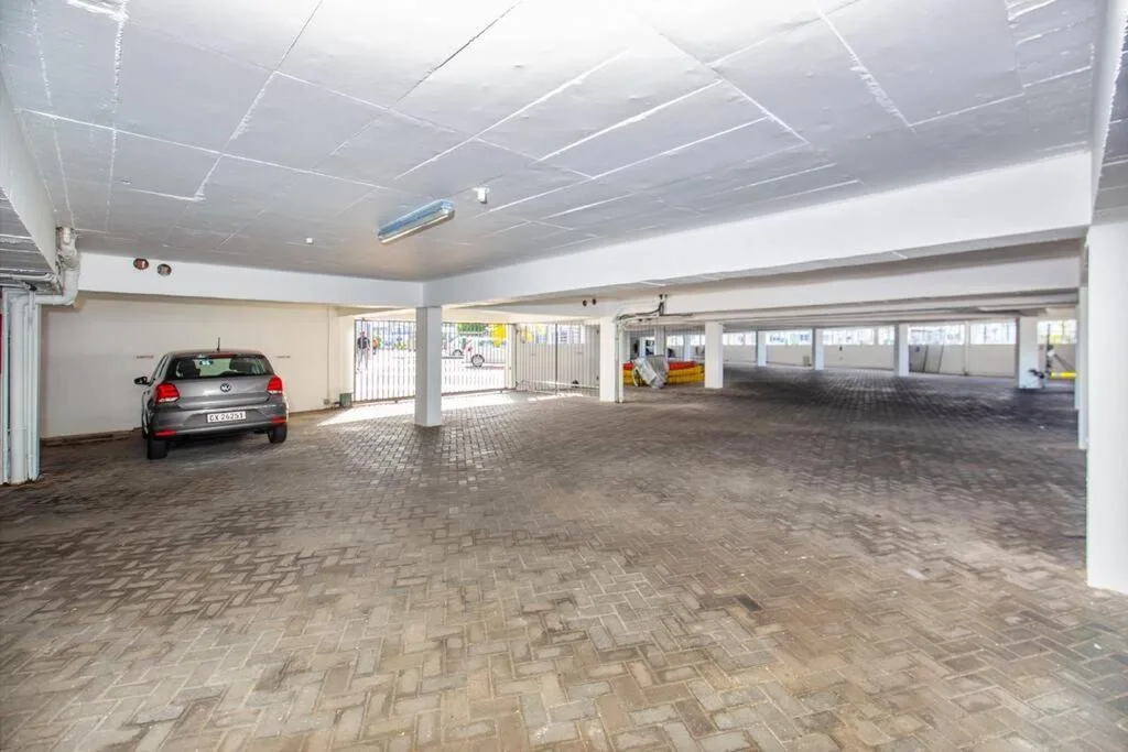 Spacious covered parking garage with brick paving and bright lighting