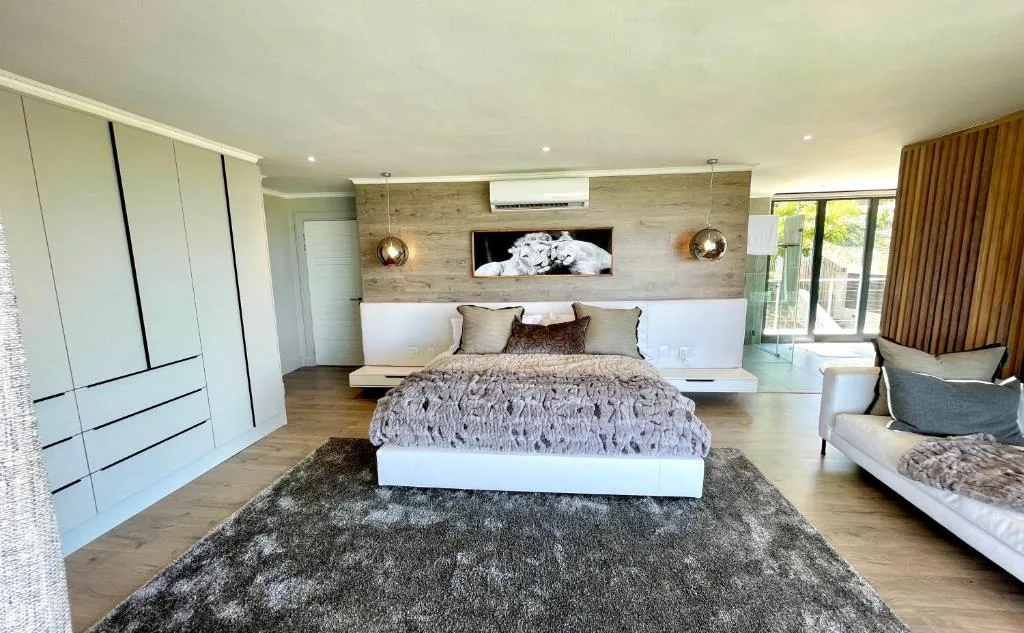 Modern bedroom with king bed, built-in wardrobes, and contemporary furnishings