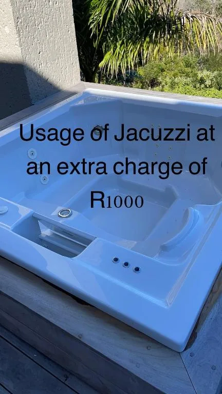 Blue hot tub with pricing text overlay in garden setting