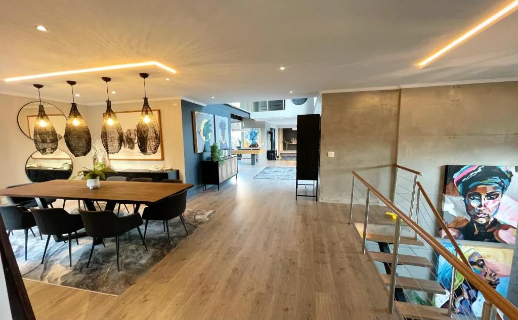 Modern dining area with wooden table, pendant lights, and contemporary decor
