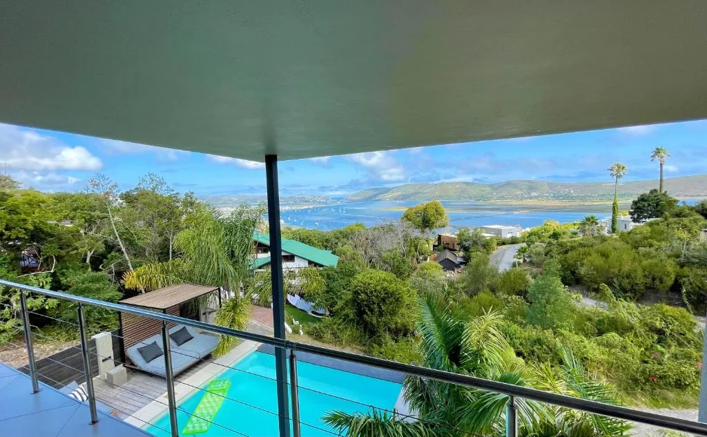 Scenic lagoon and mountain vista framed by deck railing and shade