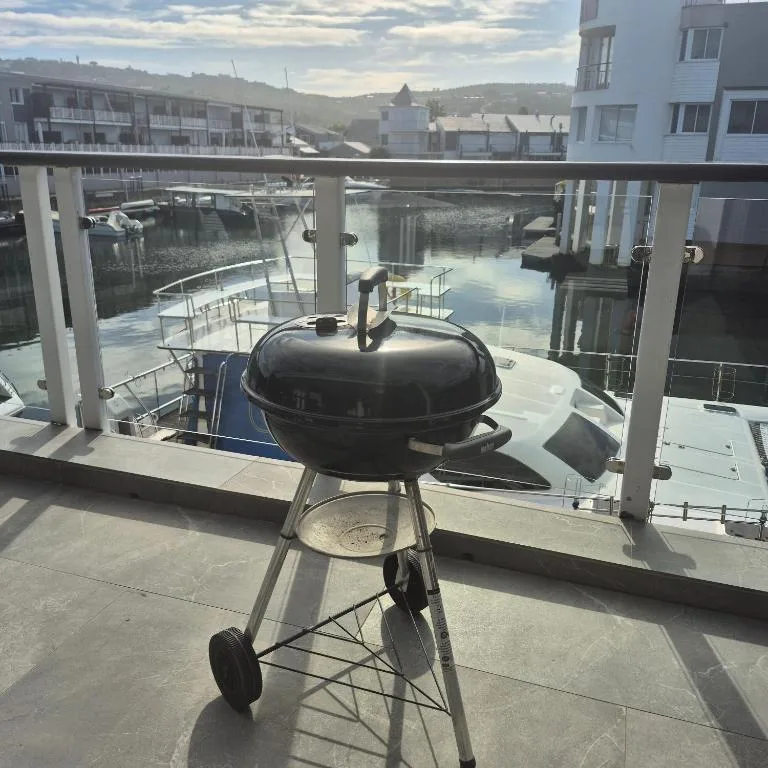 Braai grill on waterfront deck with lagoon and mountain views