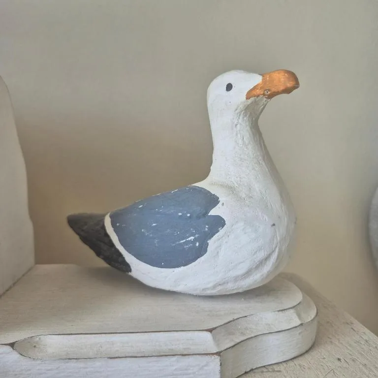Decorative wooden seagull sculpture with white and blue painted finish
