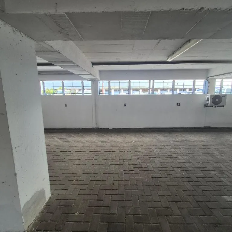 Empty parking garage interior with numbered spaces and concrete pillars