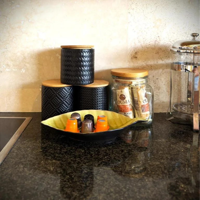 Kitchen counter styling with black storage containers and decorative accessories