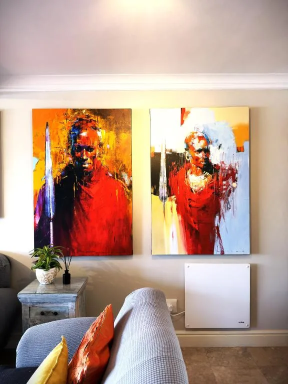Vibrant abstract art prints and decorative pillows in modern lounge