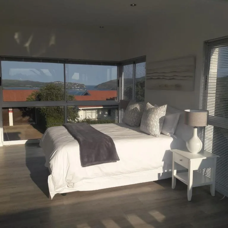 Bright bedroom with ocean and lagoon views through large windows