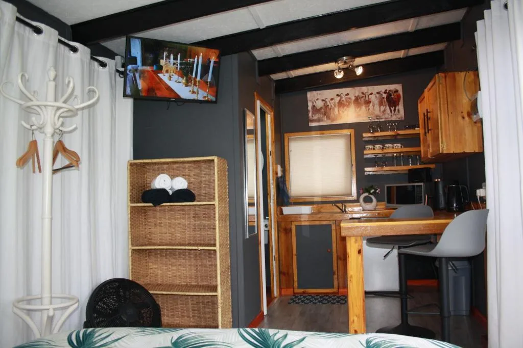 Studio apartment interior showing woven storage, desk workspace, and modern furnishings