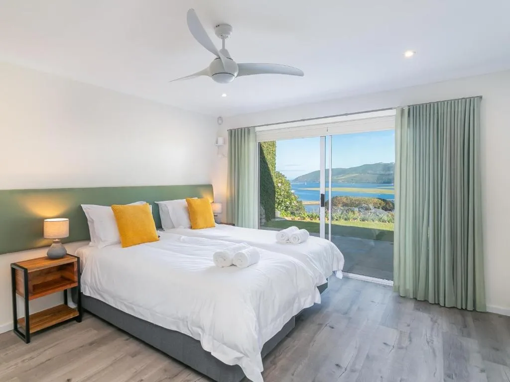 Spacious bedroom with twin beds overlooking Knysna lagoon and mountains