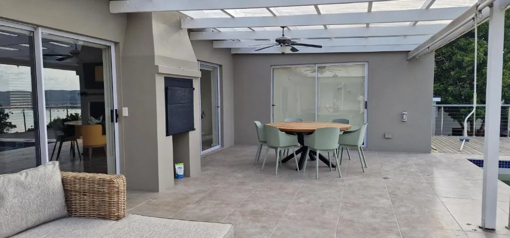 Spacious covered patio with dining table and ocean views, Knysna
