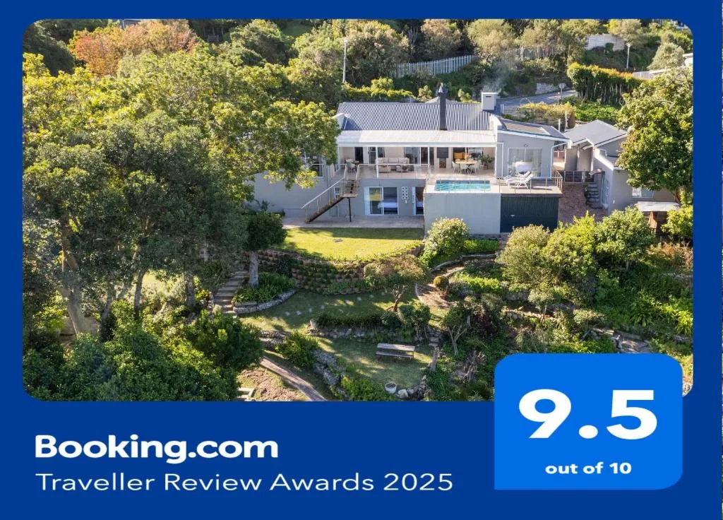 Modern villa with pool nestled in lush green gardens and trees