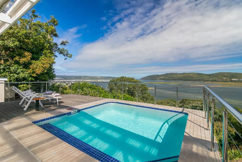 Swimming pool on wooden deck overlooking Knysna lagoon and mountains