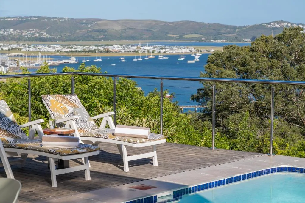 Panoramic vista of Knysna Heads lagoon with moored sailboats and mountains