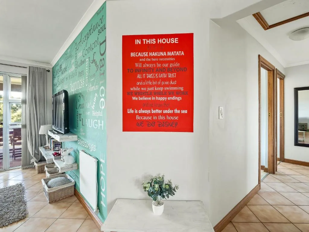 Inspirational wall art and decor in bright, airy hallway with turquoise accent wall