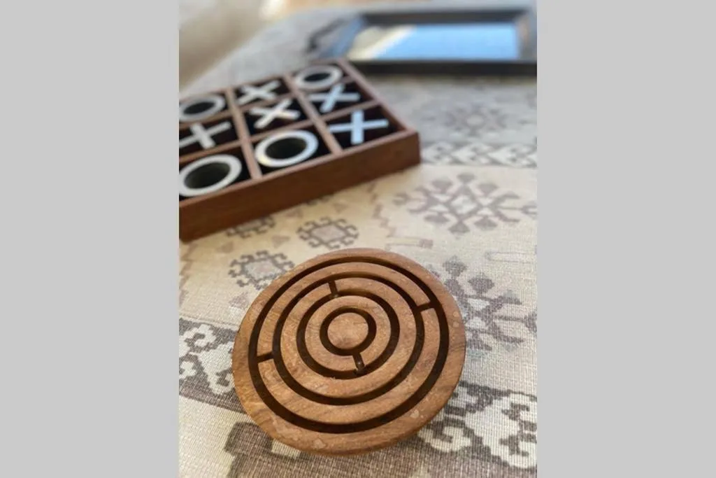 Wooden games and entertainment items arranged on patterned fabric table