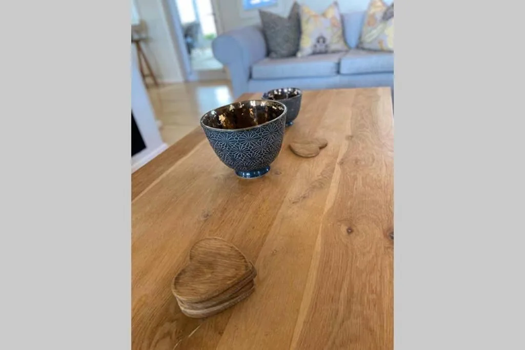 Decorative blue patterned bowls on wooden coffee table with sofa