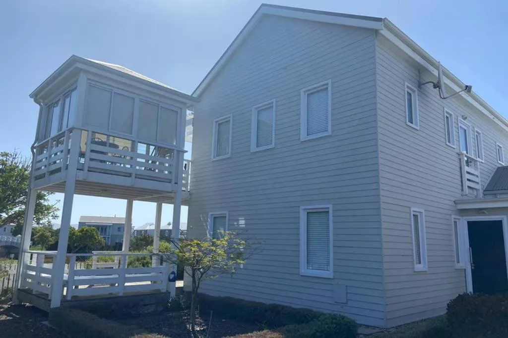 Light blue holiday home with elevated deck and multiple windows on Thesen Island