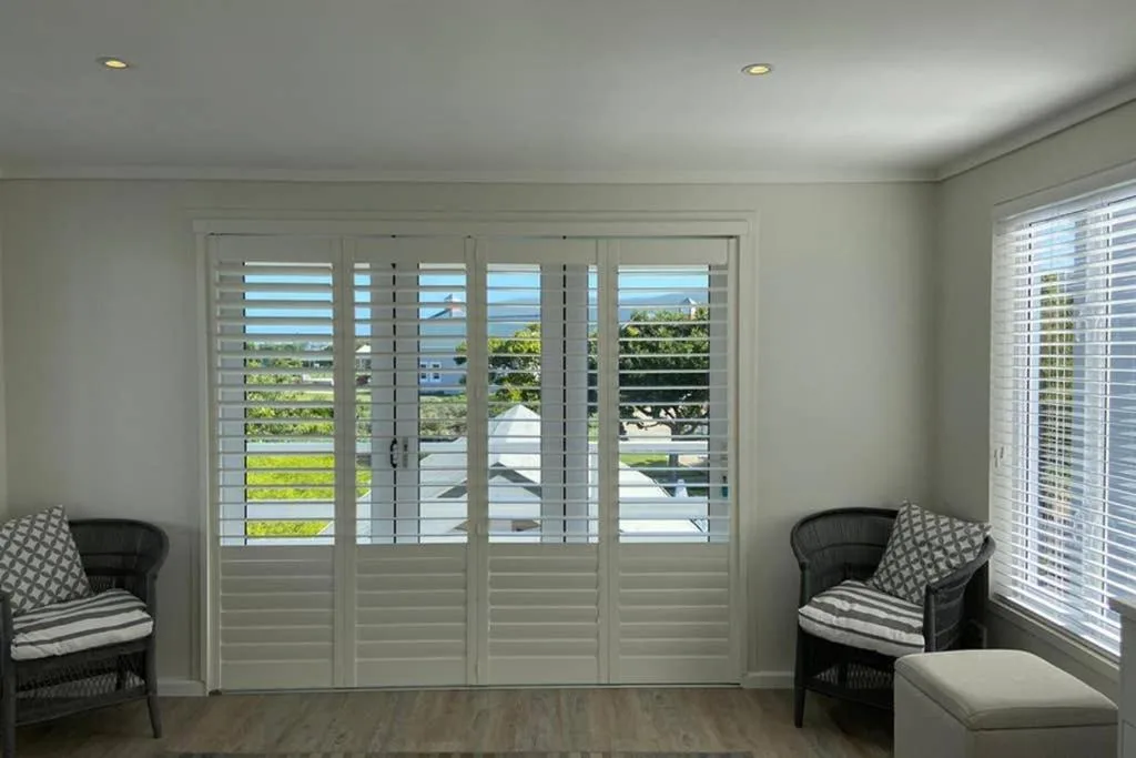 Scenic water and mountain views through lounge shuttered doors and windows