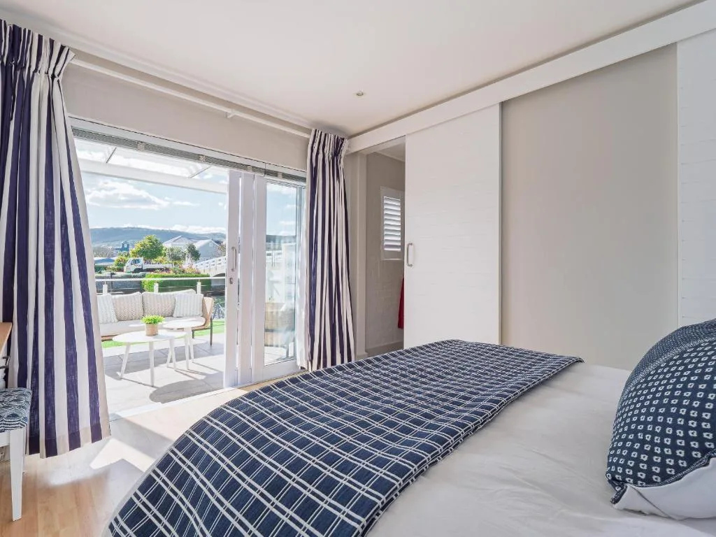 Bright bedroom with double bed and patio doors overlooking garden views