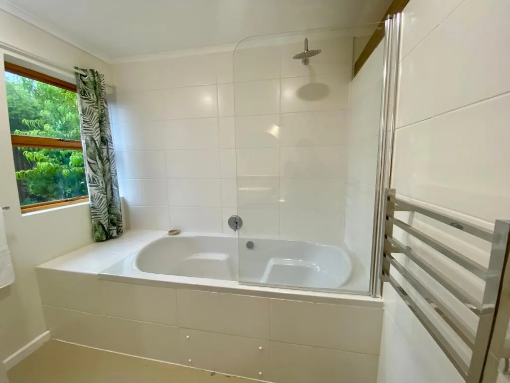 Modern bathroom with deep soaking tub and glass shower enclosure