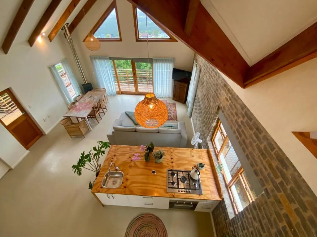 Modern kitchen with wooden countertop, gas cooktop, and skylight views