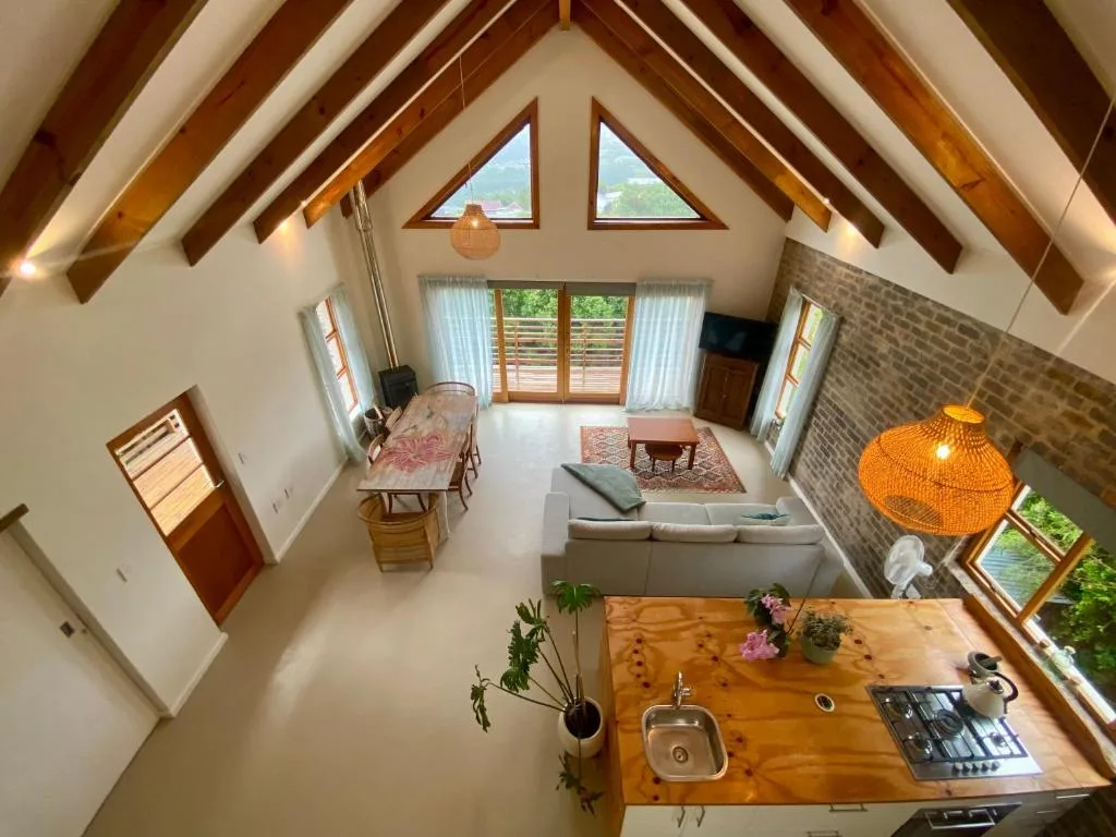 Spacious open-plan lounge with high vaulted ceilings and wooden beams